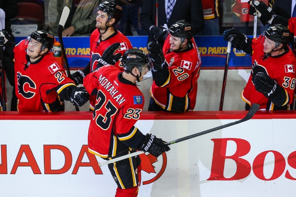 Oct 6, 2013; Calgary, Alberta, CAN; Calgary Flames center Sean Monahan (23) celebrates his goal with teammates during the third period against the Vancouver Canucks at Scotiabank Saddledome. Vancouver Canucks won 5-4. Mandatory Credit: Sergei Belski-USA T