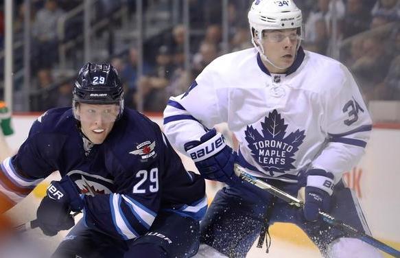 Oct 19, 2016; Winnipeg, Manitoba, CAN;  Toronto Maple Leafs center Auston Matthews (34) chases Winnipeg Jets right wing Patrik Laine (29) during the third period at MTS Centre. Winnipeg won 5-4 in overtime. Mandatory Credit: Bruce Fedyck-USA TODAY Sports